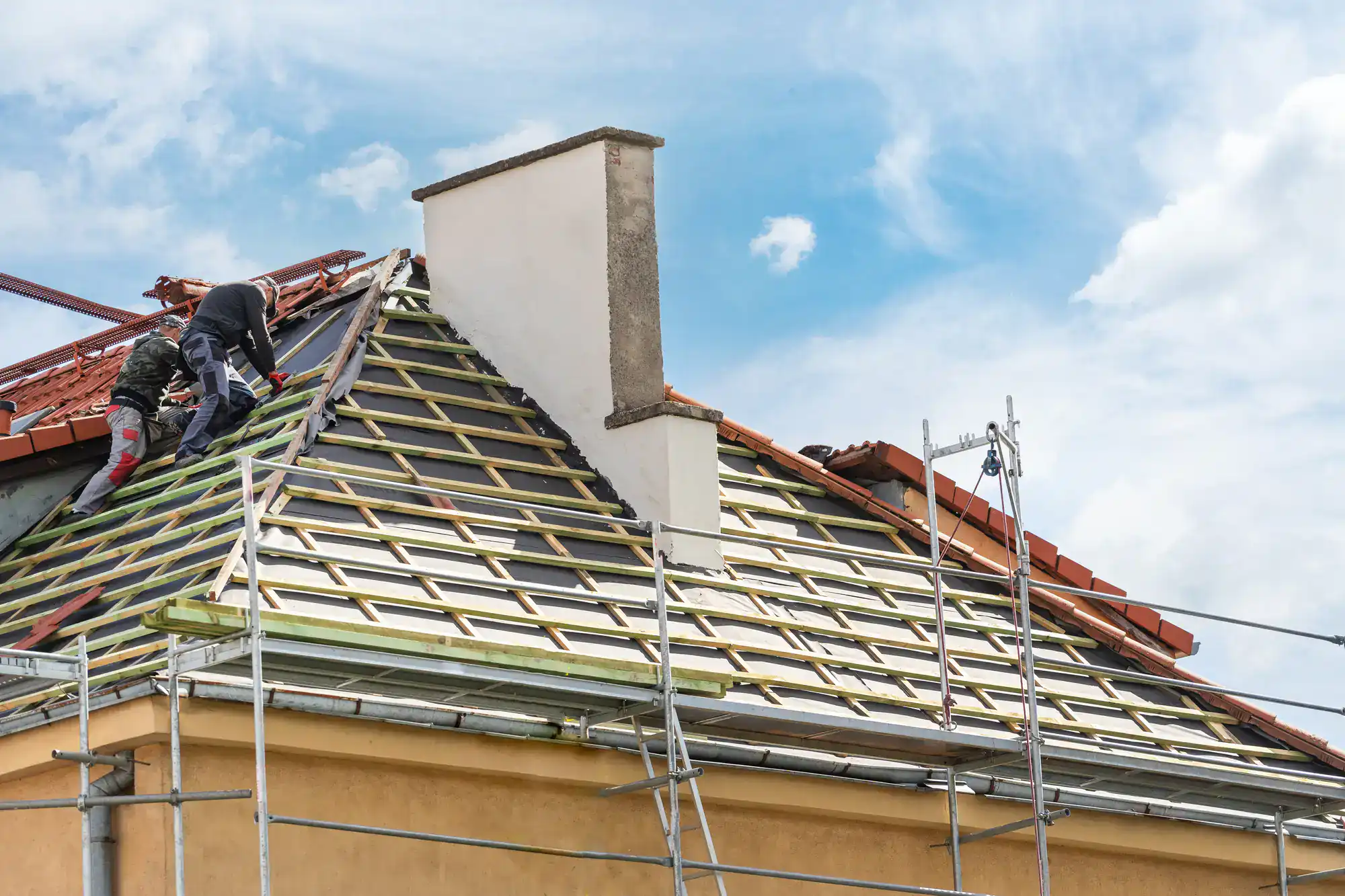 New roof installation by professional contractors at a residential home for enhanced curb appeal.