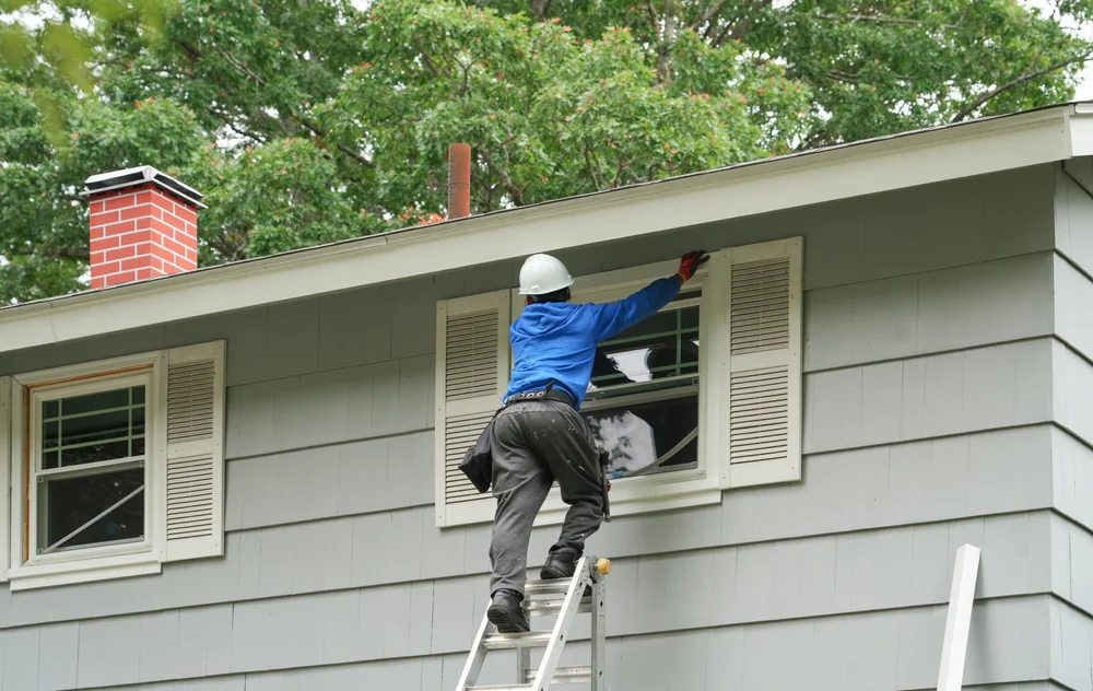 Contractor repairing a residential window in New Castle County, Delaware